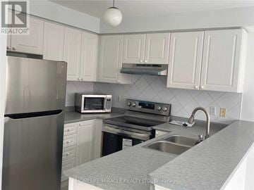 Mississauga (East Credit) townhouse for rent - A kitchen with white cabinets and a stainless steel refrigerator.