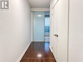 Toronto (Bay Street Corridor) condo for rent - A white hallway with a door on the right and a window on the left.