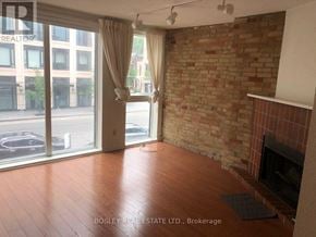 Toronto (Annex) apartment for rent - A room with a fireplace and a brick wall.