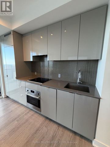 Toronto (Bay Street Corridor) condo for rent - A modern kitchen with a stainless steel oven and sink.