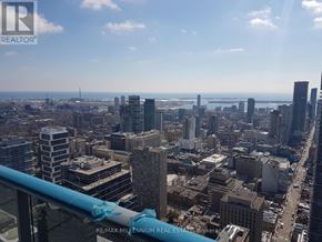 Toronto (Bay Street Corridor) condo for rent - A cityscape with a blue railing in the foreground.