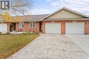 Windsor townhouse for rent - A house with a brick facade and a white garage door.