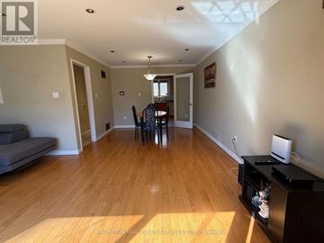 Toronto (L'amoreaux) townhouse for rent - A living room with a grey sofa and wooden floors.