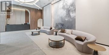 Pickering (Bay Ridges) condo for rent - A modern living room with a large sofa and a coffee table.