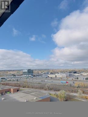 Pickering (Bay Ridges) condo for rent - A view from a window of a cityscape with buildings and a highway.