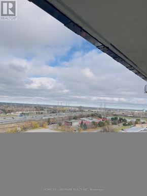 Pickering (Bay Ridges) condo for rent - A view from inside a vehicle looking out onto a landscape with a cloudy sky.