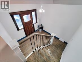 Hamilton apartment for rent - A wood staircase with a metal railing.