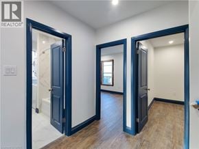 Hamilton apartment for rent - A room with a blue door and a mirror on the wall.