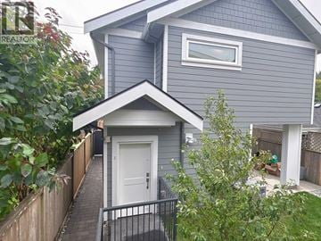 Vancouver apartment for rent - A house with a grey exterior and a white door is shown.
