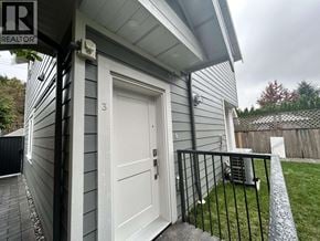 Vancouver apartment for rent - A house with a white door and a black railing.