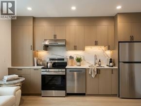 Vancouver apartment for rent - A modern kitchen with stainless steel appliances and wooden cabinets.