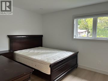 Vancouver apartment for rent - A bedroom with a large bed and a window.