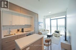 Toronto (Bayview Village) condo for rent - A modern kitchen with a large island and a dining area.