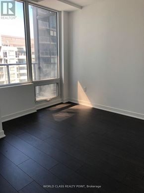 Toronto (Waterfront Communities) condo for rent - A room with a window and a view of a building outside.