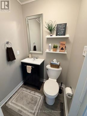Ajax (Central) apartment for rent - A bathroom with a toilet, sink, and mirror.