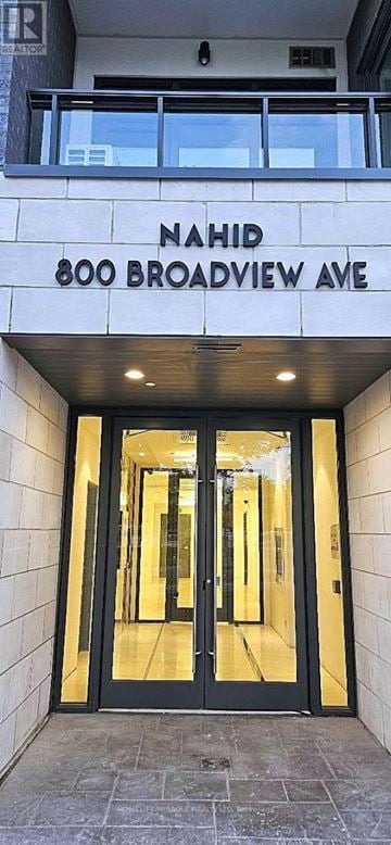 Toronto (Playter Estates-Danforth) condo for rent - The image shows the entrance to a building with a glass door and a sign that reads "Nahid 800 Broadway Ave.".
