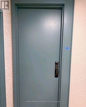 Toronto (Playter Estates-Danforth) condo for rent - A door with a handle and a small blue sticker on it.