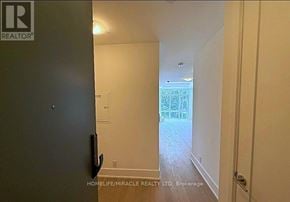 Toronto (Playter Estates-Danforth) condo for rent - A hallway with a door on the left and a door on the right.