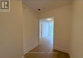 Toronto (Playter Estates-Danforth) condo for rent - A hallway with a door at the end and a light on the ceiling.