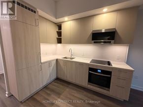 Vaughan (Vaughan Corporate Centre) condo for rent - A kitchen with wooden cabinets and a stainless steel oven.