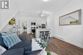 St. Catharines (E. Chester) apartment for rent - A living room with a grey couch and a wooden floor.