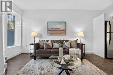 St. Catharines (E. Chester) apartment for rent - A living room with a couch, a coffee table, and a painting on the wall.