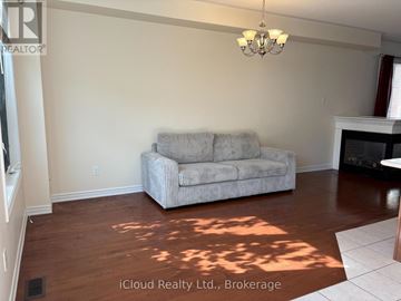 Mississauga (Hurontario) apartment for rent - A living room with a grey couch and a chandelier.