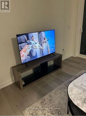 Cobourg townhouse for rent - A flat screen TV is on a stand in a room.