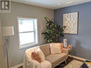 Hamilton (Gibson) apartment for rent - A living room with a couch, a lamp, a plant, and a painting on the wall.