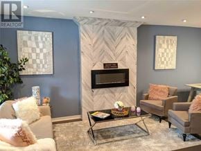 Hamilton (Gibson) apartment for rent - A living room with a grey wall and a black fireplace.