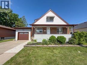 Niagara Falls apartment for rent - A house with a white garage door and a brown garage door.