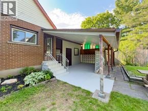 Niagara Falls apartment for rent - A house with a porch and a sign that says REALTOR.