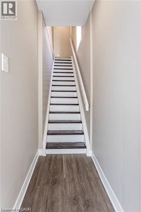 London apartment for rent - A long hallway with a staircase going up.
