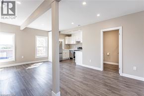 London apartment for rent - A spacious room with a kitchen area in the background.
