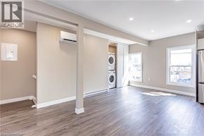 London apartment for rent - A spacious room with a washer and dryer in it.