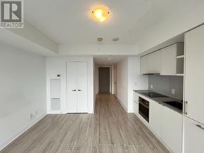 Toronto (Waterfront Communities) condo for rent - A kitchen with white cabinets and a wooden floor.