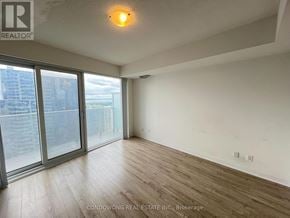 Toronto (Waterfront Communities) condo for rent - A room with a sliding glass door leading to a balcony.
