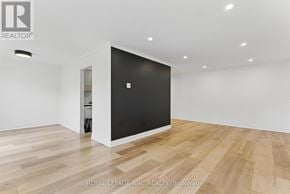 Lincoln (Beamsville) condo for rent - A room with a black door and wooden flooring.