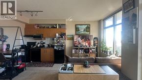 Burnaby apartment for rent - A living room with a couch, a coffee table, and a painting on the wall.