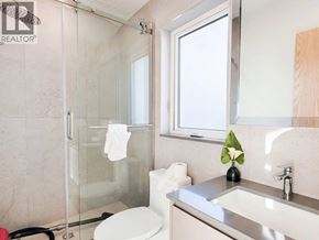 West Vancouver apartment for rent - A bathroom with a toilet, sink, and shower.