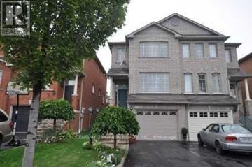 Mississauga (Cooksville) apartment for rent - A grey house with a car parked in front.