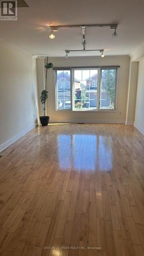 Mississauga (Cooksville) apartment for rent - A room with wooden floors and a large window.