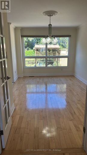 Mississauga (Cooksville) apartment for rent - A room with wooden floors and a chandelier.