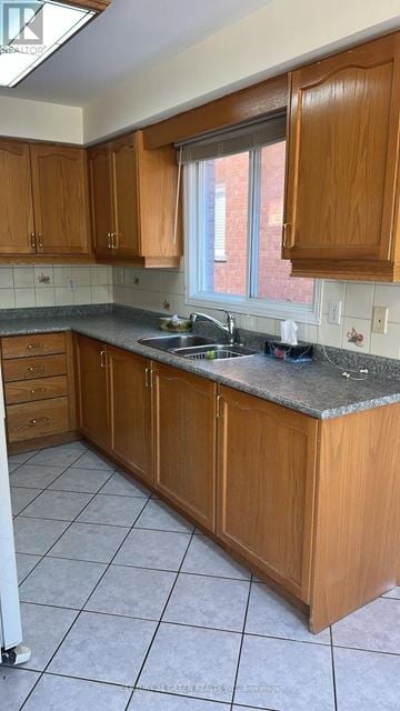 Mississauga (Cooksville) apartment for rent - A kitchen with wooden cabinets and a granite countertop.