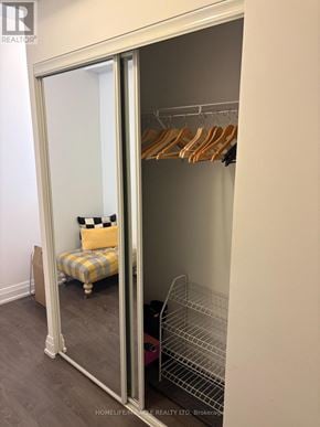 Oakville (Co Central) condo for rent - A bedroom with a bed and a wardrobe.