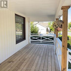 Niagara Falls (Downtown) apartment for rent - A wooden deck with a white railing and a hanging flower pot.