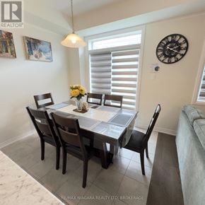 Thorold (Rolling Meadows) townhouse for rent - A dining room with a table set for four.