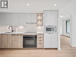 North Vancouver apartment for rent - A modern kitchen with wooden cabinets and stainless steel appliances.