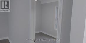 St. Catharines (Downtown) duplex for rent - A room with a white door and a window.