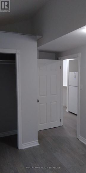St. Catharines (Downtown) duplex for rent - A white door is in a room with grey walls.